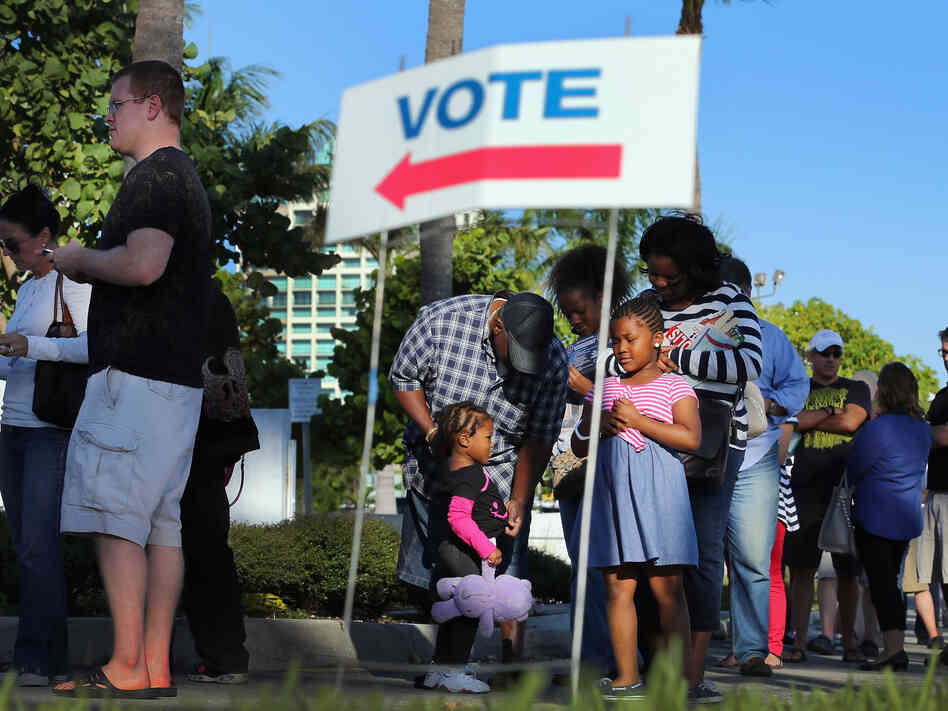 Early voters waited in line Wednesday in Miami.