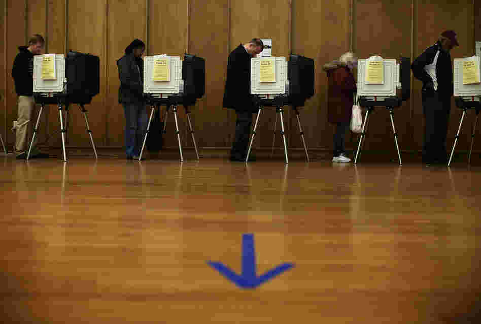 Voters cast their ballots as they participate in early voting Friday in Silver Spring, Md.