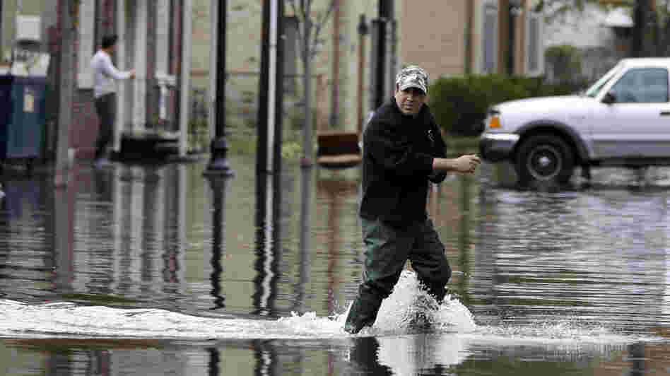 A man crosses a flooded street in the wake of Superstorm Sandy on Thursday in Little Ferry, N.J. Surprise coastal surge floods caused by the storm battered Little Ferry, Moonachie and some other towns along the Hackensack River in Bergen County, all areas unaccustomed to flooding. A man crosses a flooded street in the wake of Superstorm Sandy on Thursday in Little Ferry, N.J. Surprise coastal surge floods caused by the storm battered Little Ferry, Moonachie and some other towns along the Hackensack River in Bergen County, all areas unaccustomed to flooding.