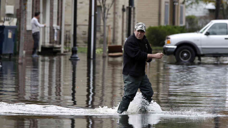 A man crosses a flooded street in the wake of Superstorm Sandy on Thursday in Little Ferry, N.J. Surprise coastal surge floods caused by the storm battered Little Ferry, Moonachie and some other towns along the Hackensack River in Bergen County, all areas unaccustomed to flooding. A man crosses a flooded street in the wake of Superstorm Sandy on Thursday in Little Ferry, N.J. Surprise coastal surge floods caused by the storm battered Little Ferry, Moonachie and some other towns along the Hackensack River in Bergen County, all areas unaccustomed to flooding.