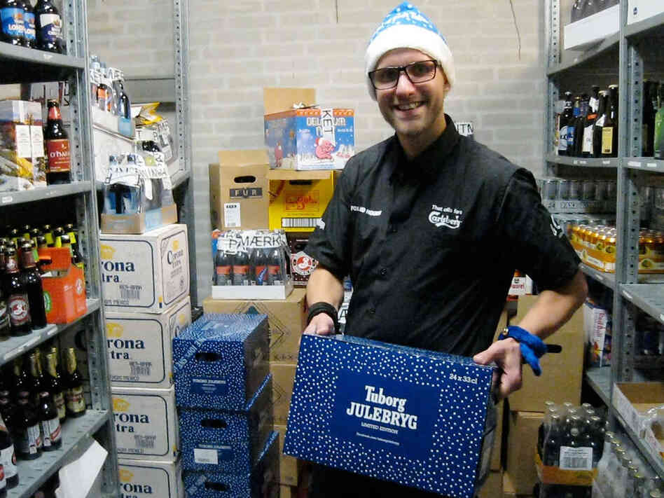 Jacob Lyby, a bar manager at Fox and Hounds in Herning, Denmark holding a case of the special Danish Christmas beer being released tonight in Denmark.