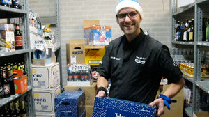 Jacob Lyby, a bar manager at Fox and Hounds in Herning, Denmark holding a case of the special Danish Christmas beer being released tonight in Denmark.