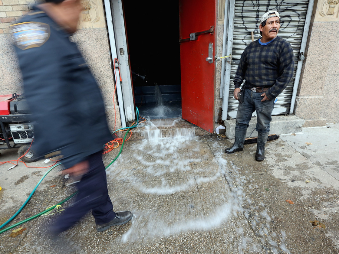 Water was being pumped out of this business in Manhattan's East Village on Thursday.