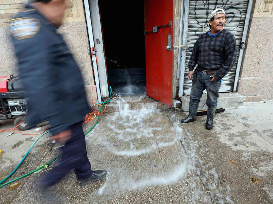 Water was being pumped out of this business in Manhattan's East Village on Thursday.