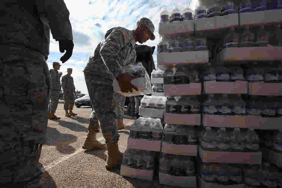 New York National Guard troops unload water to distribute to residents.