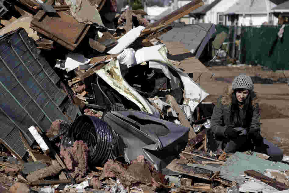 Julie Traina tries to recover some personal items from her parents' destroyed home.