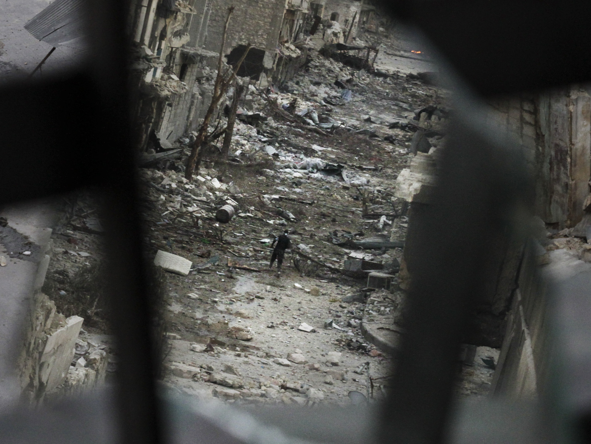 In Aleppo, Syria, this week: A rebel crossed a ruined street. This image shows him in a mirror's reflection. In Aleppo, Syria, this week: A rebel crossed a ruined street. This image shows him in a mirror's reflection.