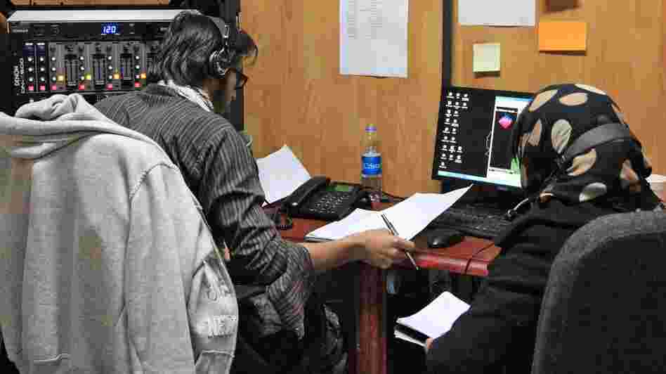 Unidentified Afghan civilians broadcast a radio program from the radio studio at Forward Operating Base Shank in Logar province, south of Kabul. The U.S. military is training Afghans to disseminate anti-insurgent messages via local radio.