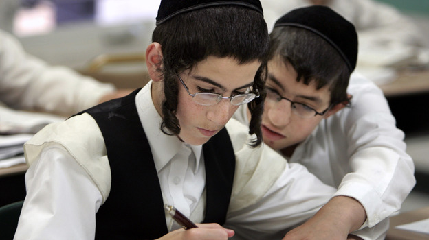 Two boys study together at a Chicago yeshiva in 2009. Public health officials say this type of close physical contact helped fuel a mumps outbreak throughout several orthodox Jewish communities in and around New York City.