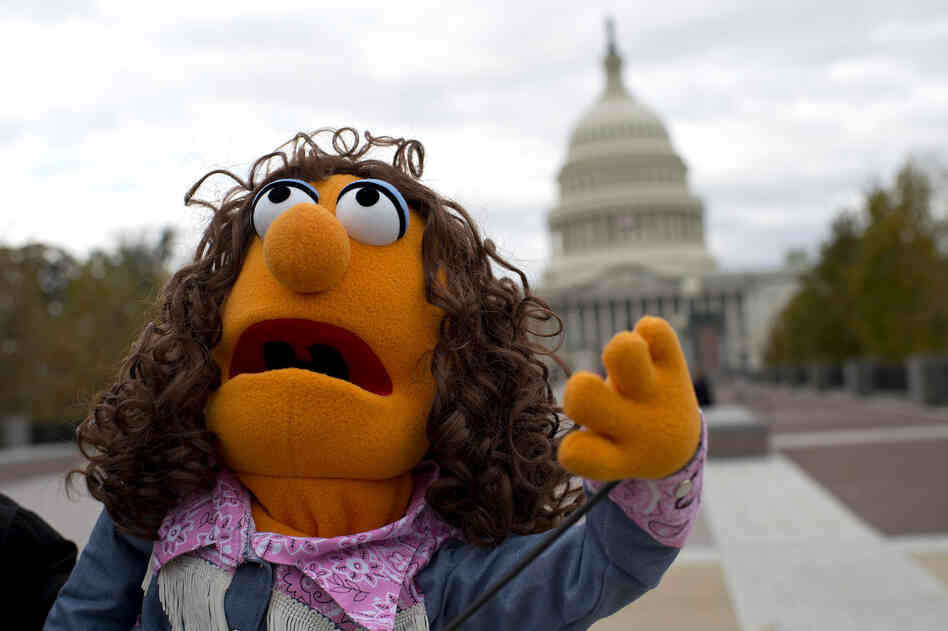 Laura Gentry holds a puppet as she shows her support for public broadcasting near the U.S. Capitol.