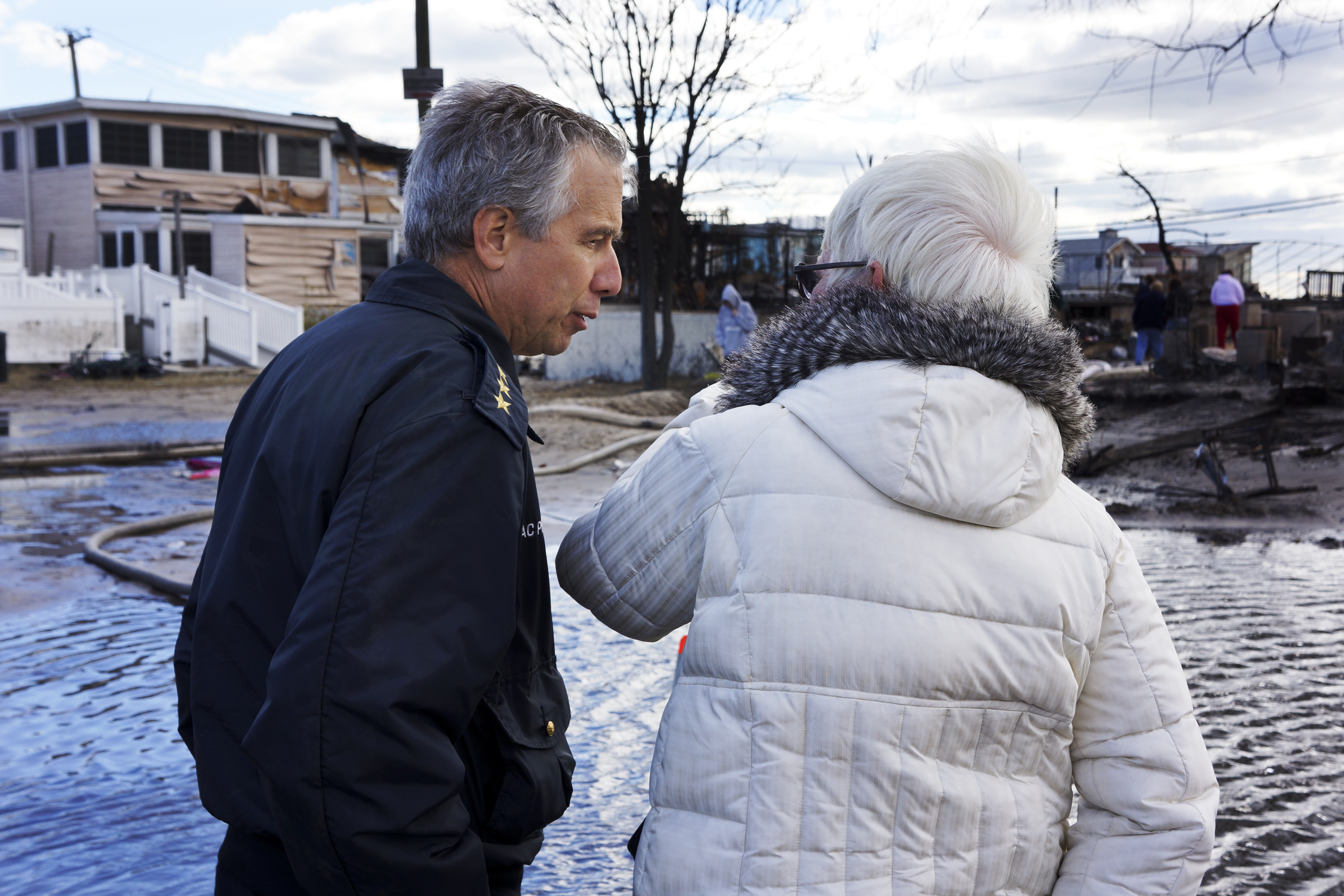 New York Fire Department Chief Joseph Pfeifer consoles a woman who lost her home. 111 homes were lost in this small seaside community, as fires raged in the 50 mile an hour winds if Superstorm Sandy. New York Fire Department Chief Joseph Pfeifer consoles a woman who lost her home. 111 homes were lost in this small seaside community, as fires raged in the 50 mile an hour winds if Superstorm Sandy.