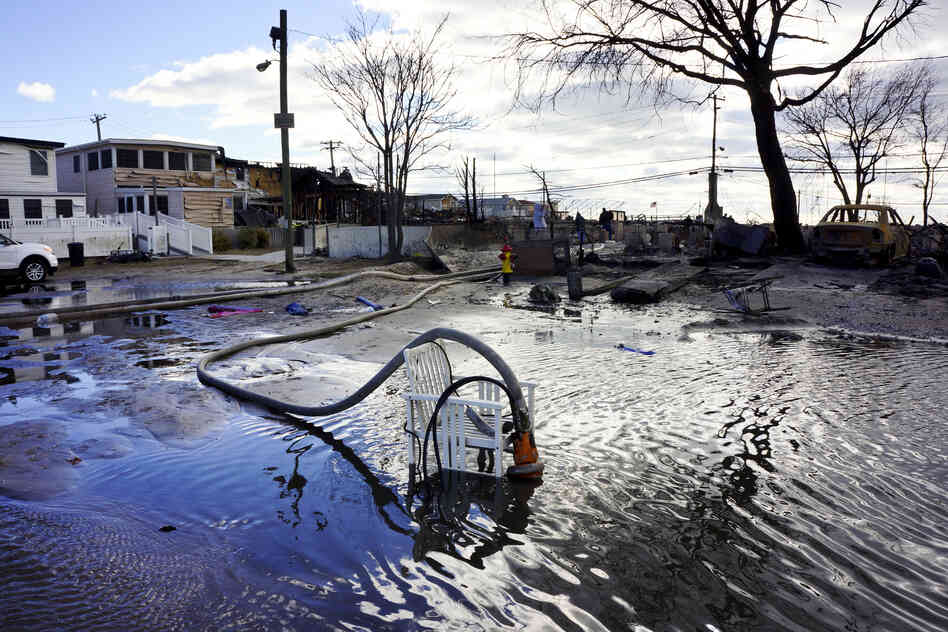 Firefighters are part of a massive de-watering effort in Breezy Point. "We're trying to put the water back where it came from," says Chief Pfeifer.