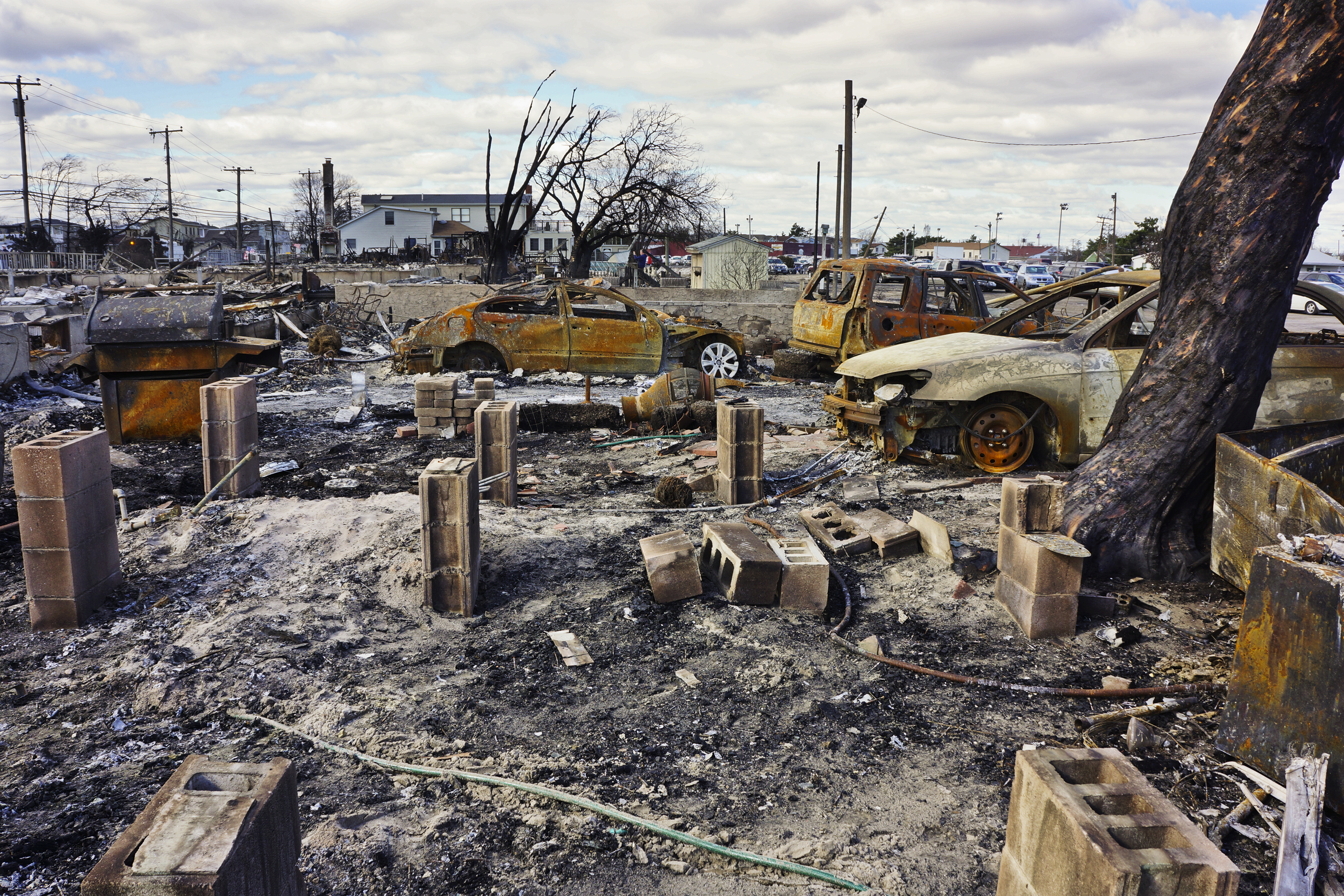 Everyone in the community has been evacuated and no deaths where reported as a result of the Breezy Point fire. Summer cars and barbecues were among the few recognizable signs of life after the fire. Everyone in the community has been evacuated and no deaths where reported as a result of the Breezy Point fire. Summer cars and barbecues were among the few recognizable signs of life after the fire.