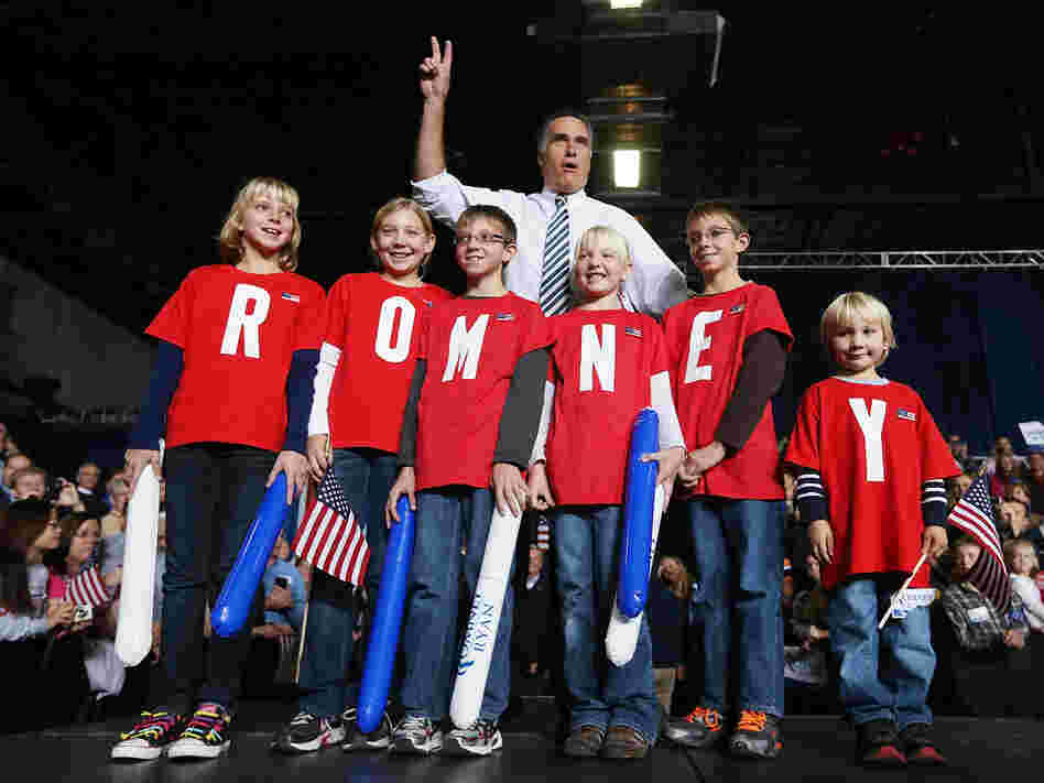 Republican presidential candidate Mitt Romney poses with children during a campaign rally in Des Moines, Iowa, on Sunday.