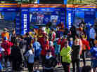 A crowd of runners stands near the barricaded Central Park finish line for the now-canceled New York Marathon on Saturday.