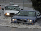 Motorists drive through standing water at an intersection flooded from the remnants of Tropical Storm Ida in the Ocean View area of Norfolk, Va., in November 2009. Motorists drive through standing water at an intersection flooded from the remnants of Tropical Storm Ida in the Ocean View area of Norfolk, Va., in November 2009.