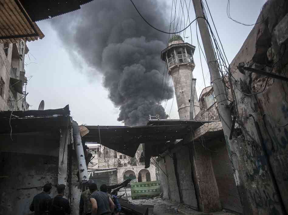 Rebel fighters watch as smoke rises after Syrian government forces fired an artillery round at a rebel position during heavy clashes in the Jedida district of Aleppo, Syria, on Sun., Nov. 4. Rebel fighters watch as smoke rises after Syrian government forces fired an artillery round at a rebel position during heavy clashes in the Jedida district of Aleppo, Syria, on Sun., Nov. 4.