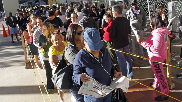 Floridians stand in line during the last day of early voting in Miami on Saturday. A judge extended early-voting hours in one Florida county Sunday after Democrats sued to allow more time.