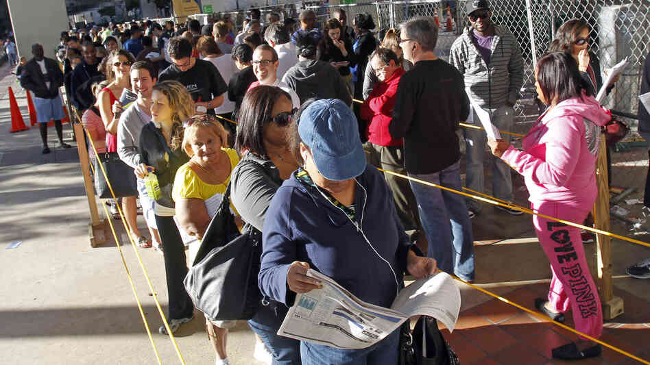 Floridians stand in line during the last day of early voting in Miami on Saturday. A judge extended early-voting hours in one Florida county Sunday after Democrats sued to allow more time.