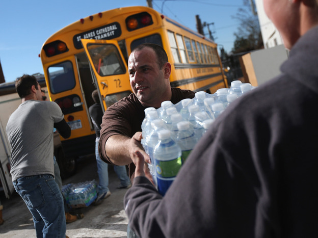 Long Beach, N.Y.: Volunteers unloaded water at an aid distribution center on Sunday.