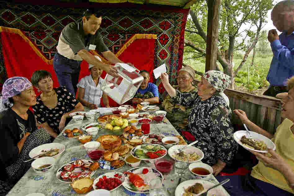 In Kyrgyzstan, Toktobubu Jantaliyeva (third from right) casts a presidential ballot as she and her relatives have lunch in their country house in the village of Gornaya, 2005.