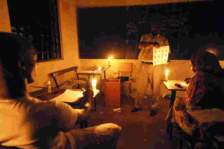 In Comoros, electoral agents count ballots by candlelight after the nation voted to replace their incumbent president, 2010.
