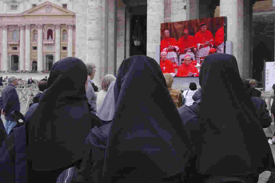 Nuns outside the Vatican watch a telecast of cardinals deliberating at the Papal Conclave to elect a new pope in 2005. The government of Vatican City, an ecclesiastical state, is overseen by the pope of the Roman Catholic church, who can only be elected by male cardinals.