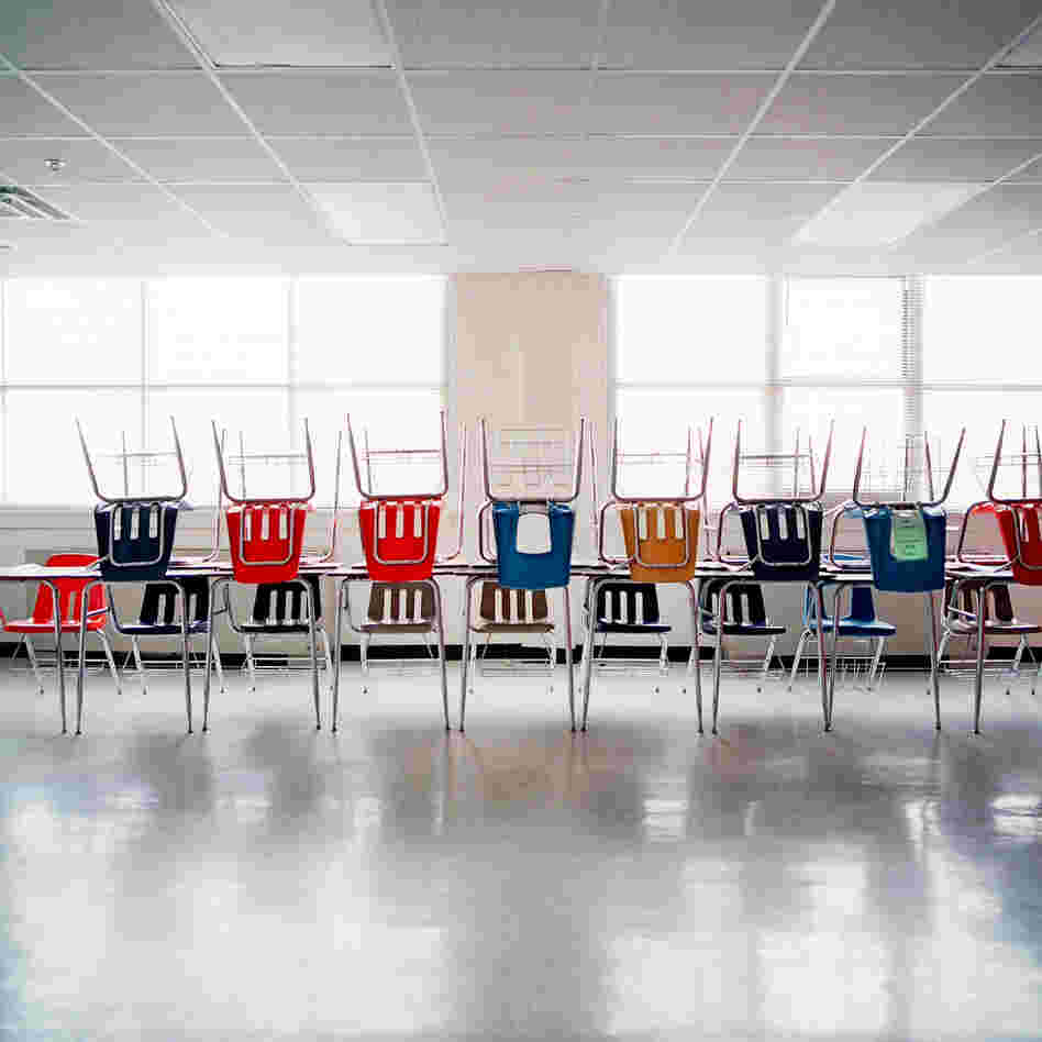 Desks are piled on top of each other at H.S. Thompson Elementary School.