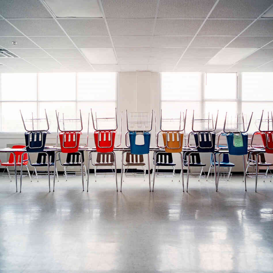 Desks are piled on top of each other at H.S. Thompson Elementary School.