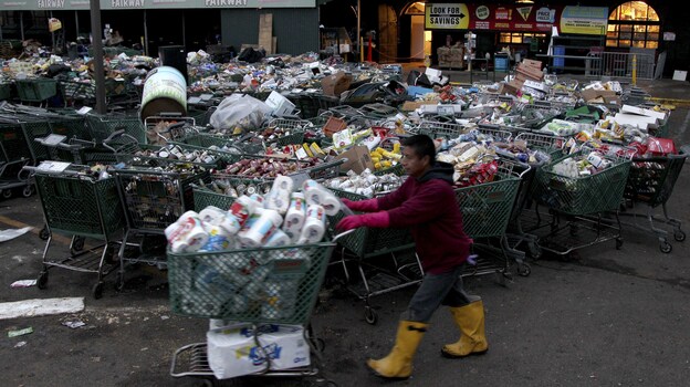 Shopping carts full of food damaged by Sandy await disposal at Fairway. (AP)