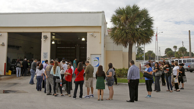 Voters stand in line as they prepare to cast their votes in Hialeah, Fla., on Tuesday. (AP)