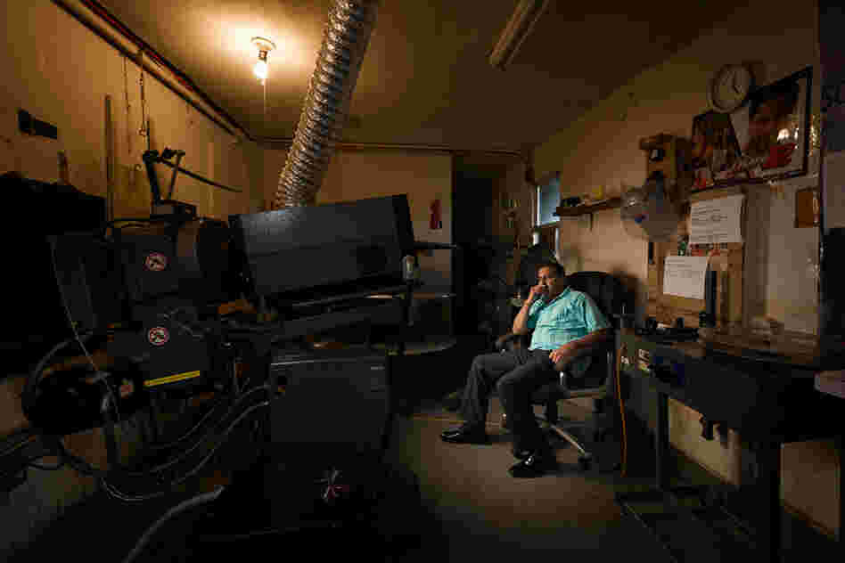 Manager Tushar Kshatriya in the booth of the Bombay Theater.