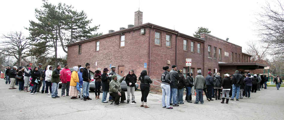 African-American turnout and enthusiasm for Obama are matching levels seen four years ago. Above, voters wait in a long line in Detroit, Mich., on Tuesday.