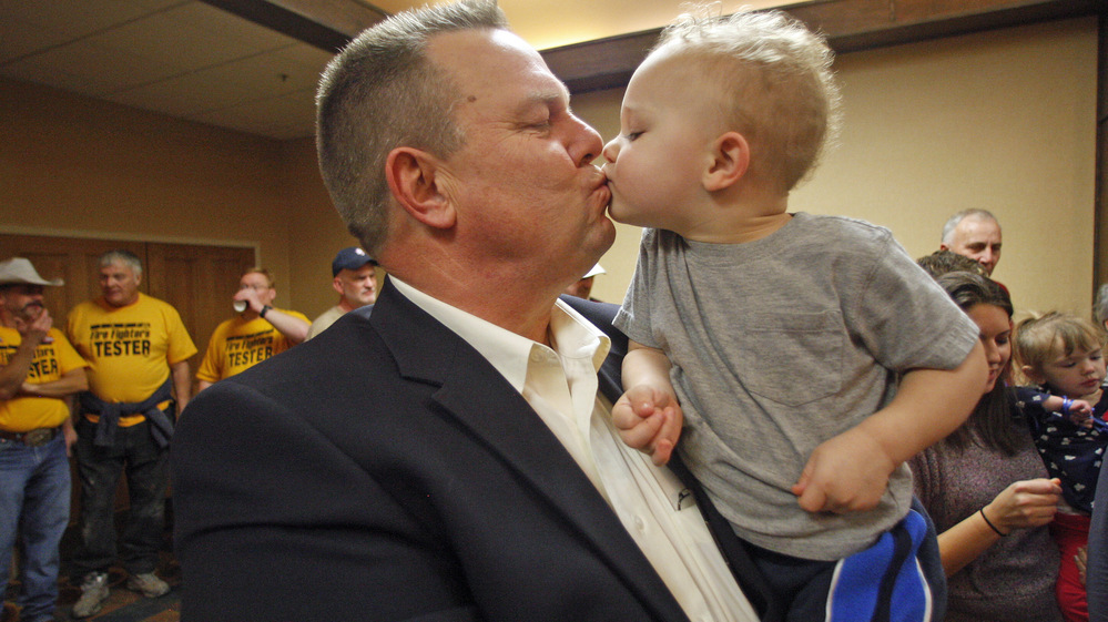Sen. Jon Tester, D-Mont., receives a kiss from his grandson Wednesday in Great Falls, Mont. Tester won re-election in a tight contest with Republican Rep. Denny Rehberg.
