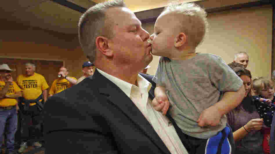 Sen. Jon Tester, D-Mont., receives a kiss from his grandson Wednesday in Great Falls, Mont. Tester won re-election in a tight contest with Republican Rep. Denny Rehberg.