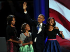 President Obama walks on stage with first lady Michelle Obama and daughters Sasha and Malia to deliver his victory speech on election night in Chicago.