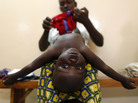 A mother dresses her baby after doctors examined him during the malaria vaccine trial at the Walter Reed Project Research Center in Kombewa in Western Kenya in October 2009. A mother dresses her baby after doctors examined him during the malaria vaccine trial at the Walter Reed Project Research Center in Kombewa in Western Kenya in October 2009.