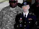 Army Pfc. Bradley Manning (right) is escorted out of a courthouse in Fort Meade, Md., on June 25, 2012. His lawyer announced that Manning, who is accused of leaking classified information to WikiLeaks, had agreed to plead guilty to lesser charges.