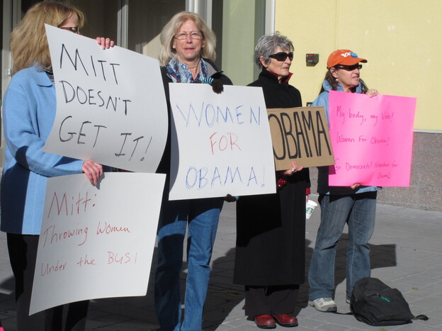 On Oct. 24, women backing President Obama protest outside a convention center in Reno, Nev., where Republican Mitt Romney was giving a campaign speech. Exit polls show significant support from women was a key factor in Obama's victory over Romney in Nevada.