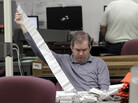 A Miami-Dade Elections Department employee tallies absentee ballot reports in Doral, Fla., on Thursday. A Miami-Dade Elections Department employee tallies absentee ballot reports in Doral, Fla., on Thursday.