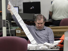 A Miami-Dade Elections Department employee tallies absentee ballot reports in Doral, Fla., on Thursday. A Miami-Dade Elections Department employee tallies absentee ballot reports in Doral, Fla., on Thursday.
