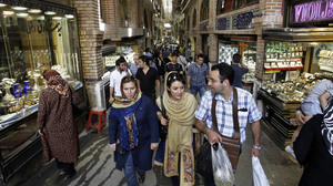 Iranians make their way through Tehran's main bazaar. Iran's economy is under increasing strain, and its currency has fallen sharply.