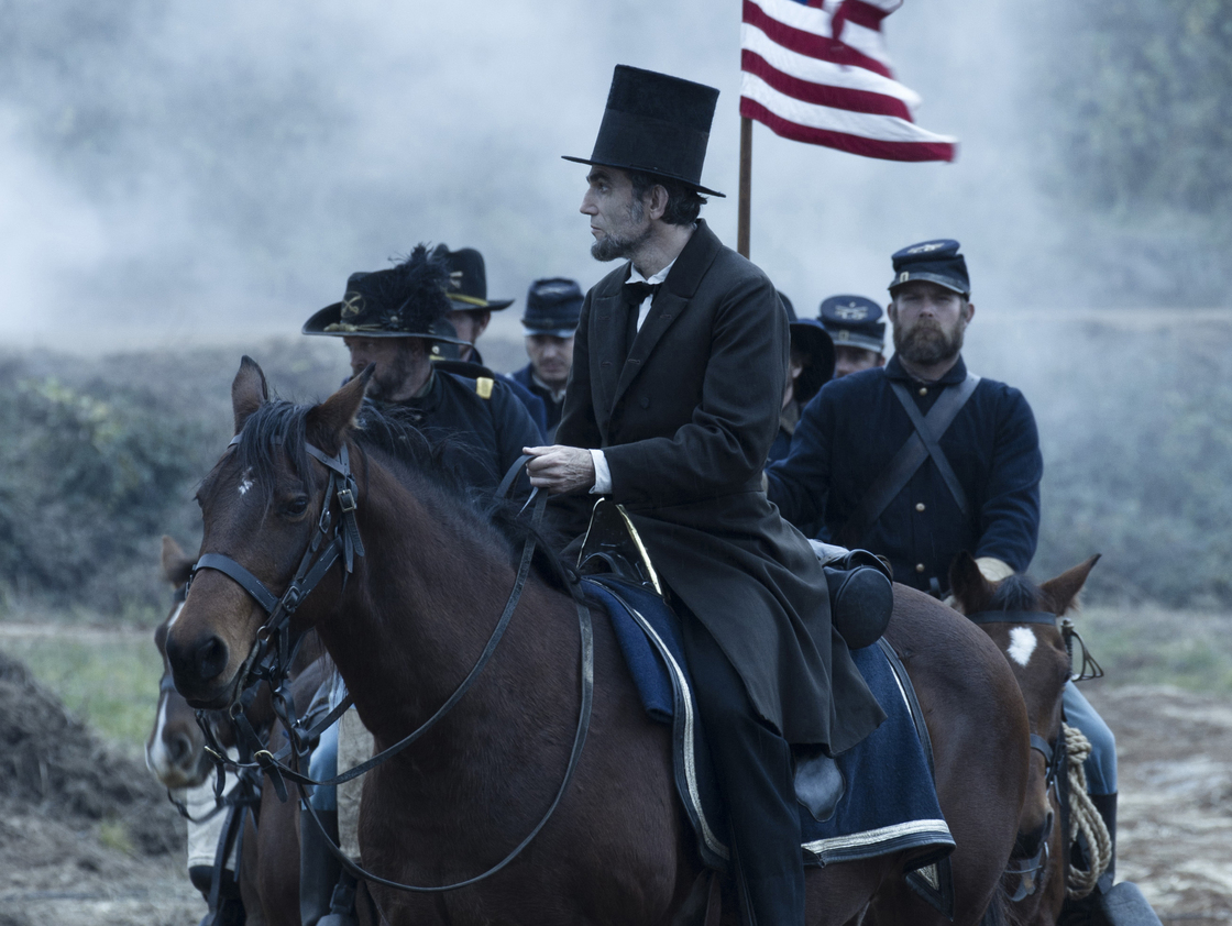 President Abraham Lincoln (Daniel Day-Lewis) looks across a battlefield in the aftermath of a terrible siege in Lincoln.