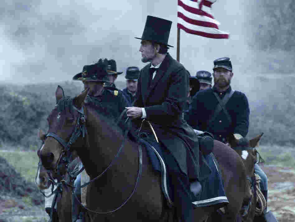 President Abraham Lincoln (Daniel Day-Lewis) looks across a battlefield in the aftermath of a terrible siege in Lincoln.
