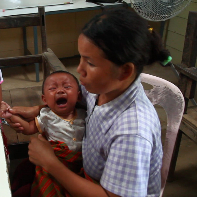 Medical staff at the Whampa clinic on Thailand-Burma border take a small blood sample from an infant to test for malaria. Children under the age of 5 are especially vulnerable to the disease.