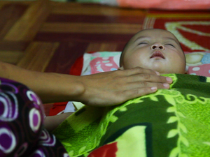 A mother comforts her sick child at the Whampa malaria clinic on the Thailand-Burma border. Children under 5 years of age are especially vulnerable to the disease. A mother comforts her sick child at the Whampa malaria clinic on the Thailand-Burma border. Children under 5 years of age are especially vulnerable to the disease.