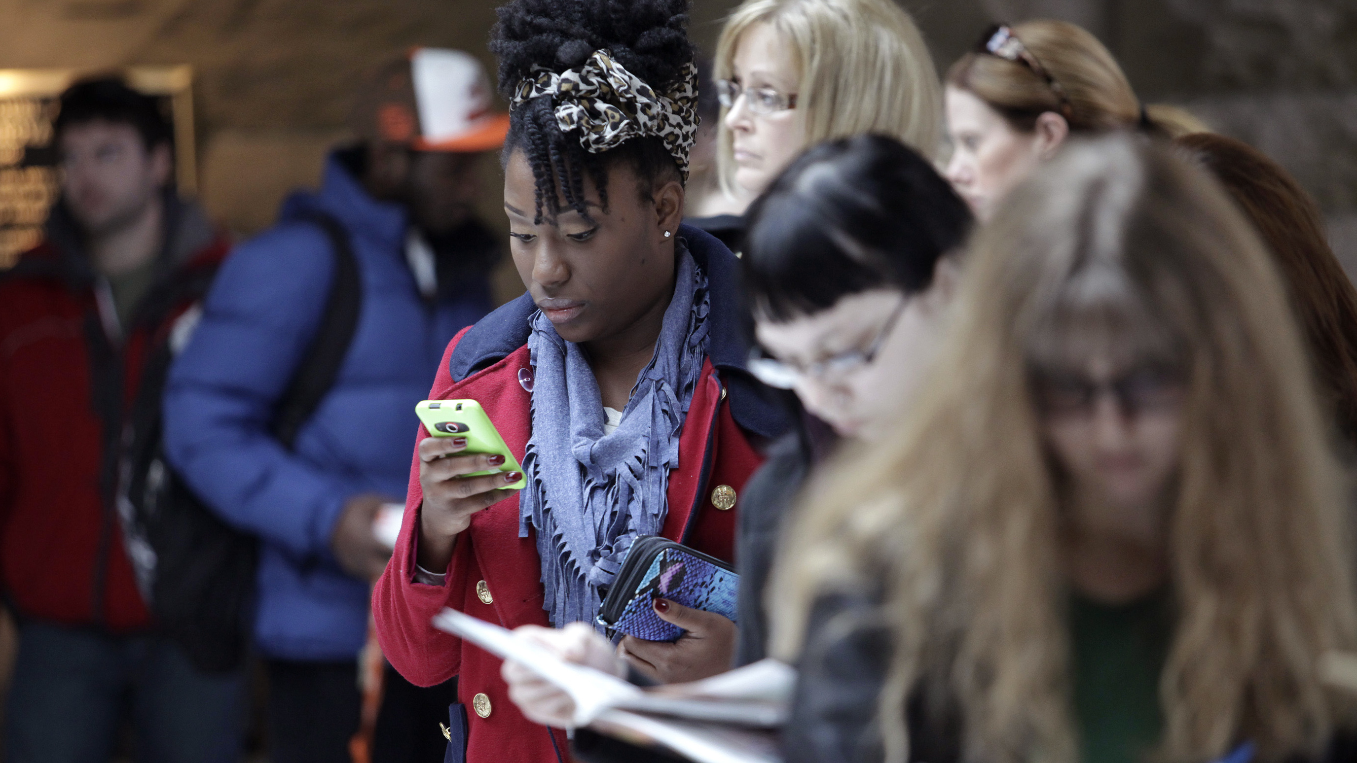 Elizabeth Ball checks her phone while waiting to vote Monday in Bowling Green, Ohio. Elizabeth Ball checks her phone while waiting to vote Monday in Bowling Green, Ohio.