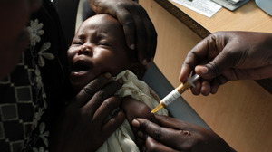 A mother held her baby as she received an experimental malaria vaccine at the Walter Reed Project Research Center in Kombewa in Western Kenya in October 2009.