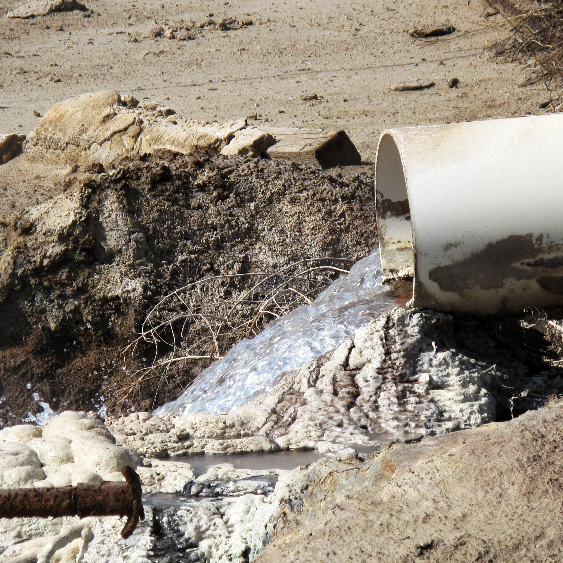 Internal EPA documents released to NPR show some EPA staffers have been trying to figure out what is in the wastewater released by oil companies. There are lots of chemicals. Some leave solid residues like these white and gray mounds. Danger signs near this outflow pipe warn that poisonous gas fumes from the water can cause respiratory irritation or suffocation.