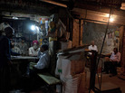 Indian workers at a spare parts store discuss business as the proprietor of a neighboring business sits in his shop in New Delhi. Indian workers at a spare parts store discuss business as the proprietor of a neighboring business sits in his shop in New Delhi.